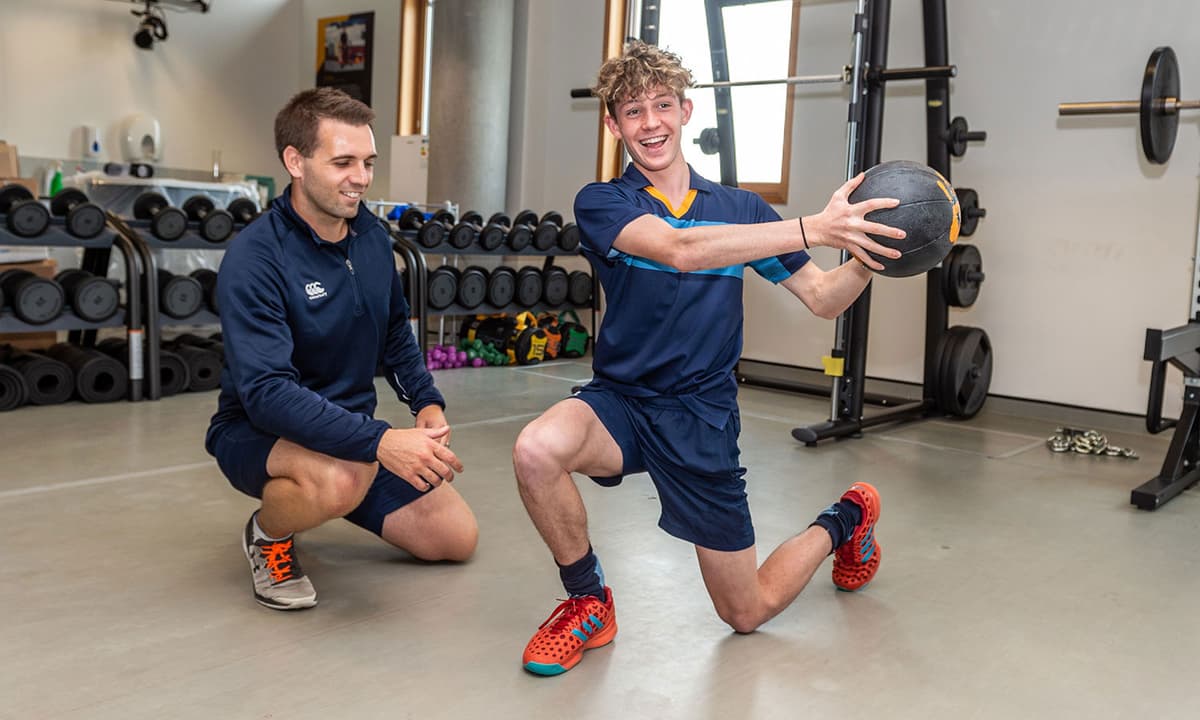 Athlete performing lunge ball twist exercise